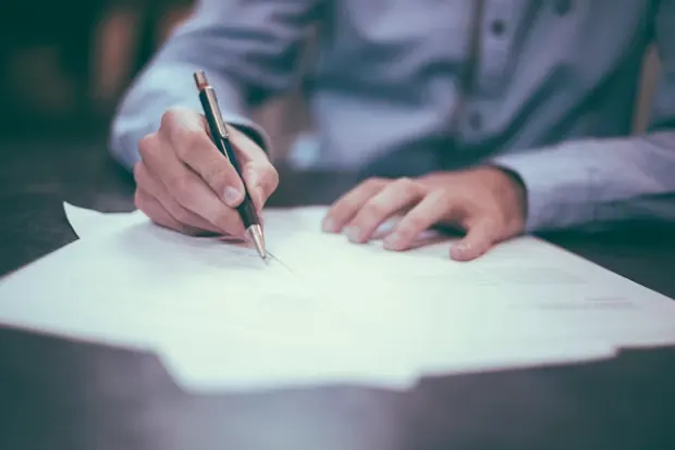 Student signing education loan documents